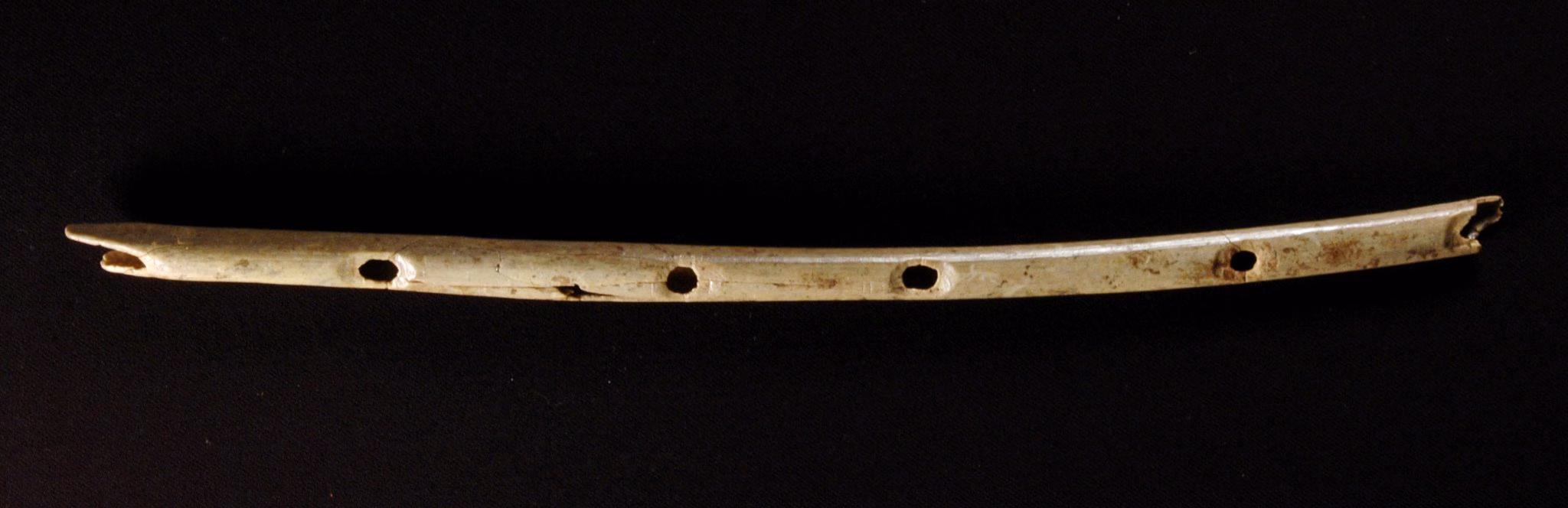 Close-up of the original flute artifact being stabilized.
